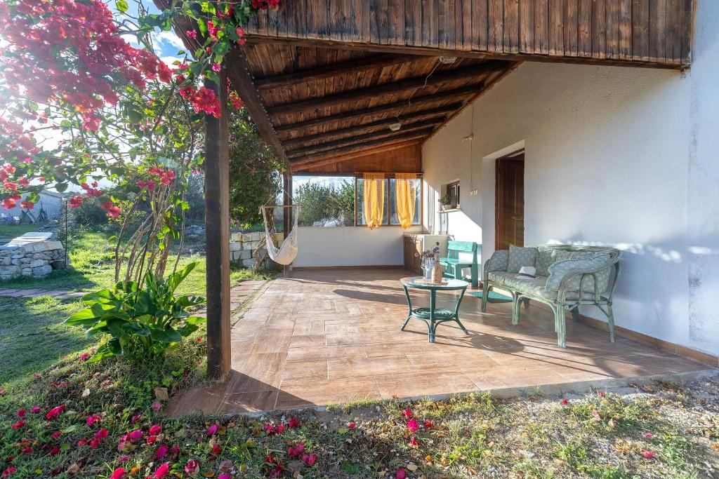 a patio with a table and chairs on it at Domo Clelia in Nulvi