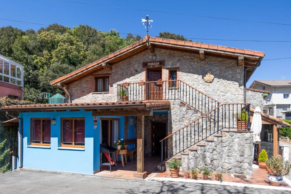 a small stone house with a blue facade at Posada Paraso Iris in Isla
