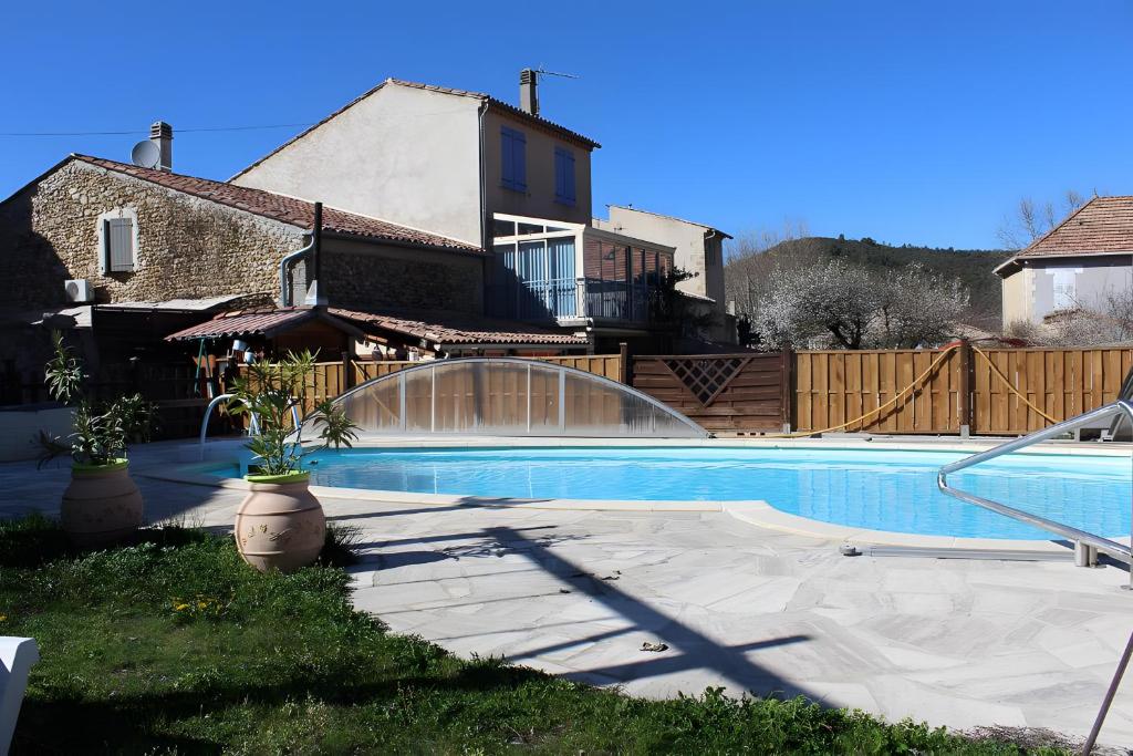 a swimming pool in front of a house at Gîte Marion in Allemagne-en-Provence