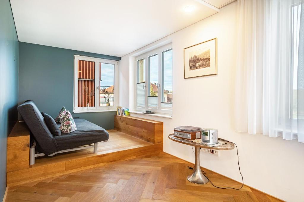 a living room with a chair and a table at Ferienwohnung Lauterach in Lauterach