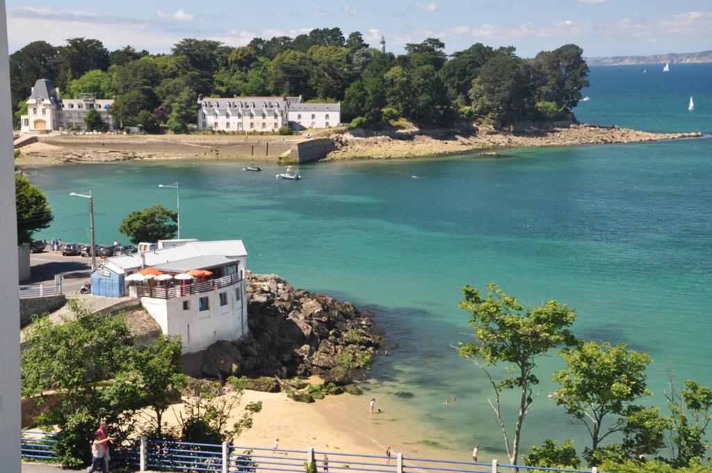a house on the shore of a body of water at Appartement face Mer - 50m plage in Douarnenez