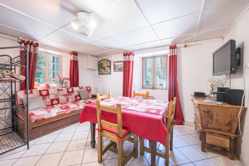 a dining room with a table and a couch at Rose Des Neiges in Valloire