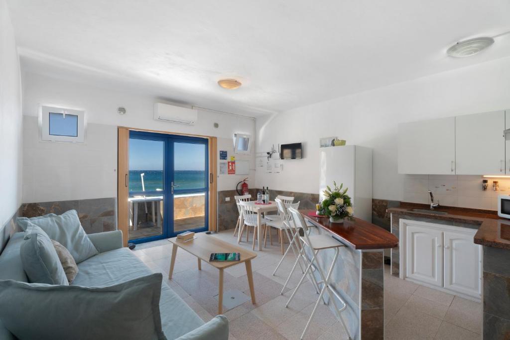 a kitchen and living room with a couch and a table at Apartamentos Playa Azul - 3 in Vallehermoso
