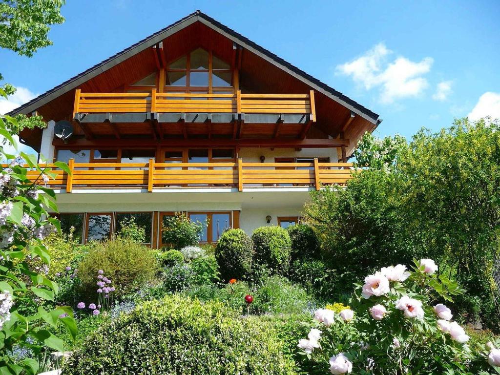 a house with a garden in front of it at Haus am See in Illmensee