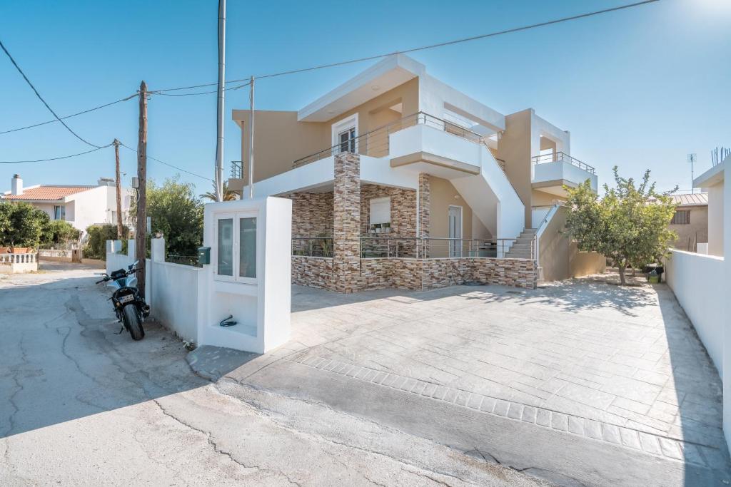 a villa with a gate in front of a house at Velvet Apartments in Rhodes Town