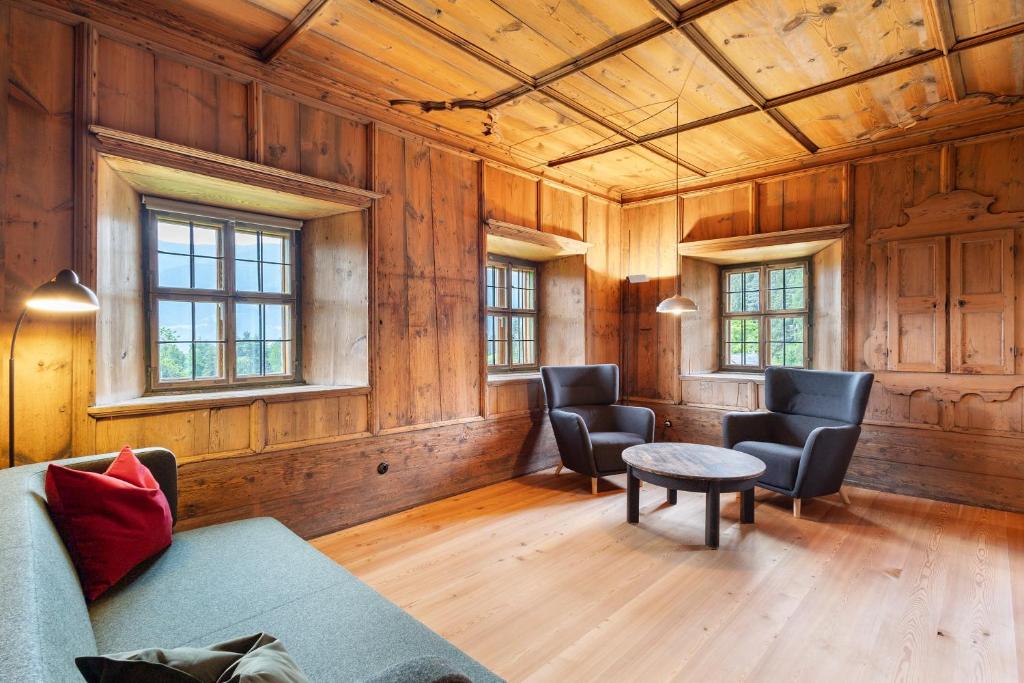 a living room with a couch and chairs and a table at Ansitz Baumannhof Apt 1818 in Falzes
