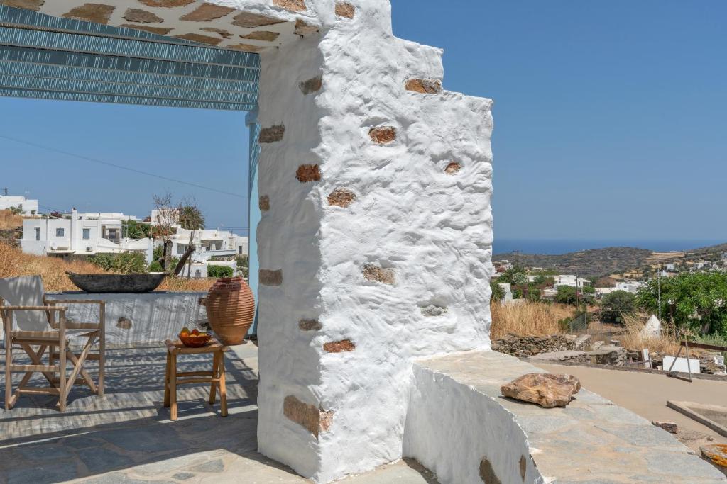 a view from the patio of a house with a stone wall at Sylvia's Home in Sifnos