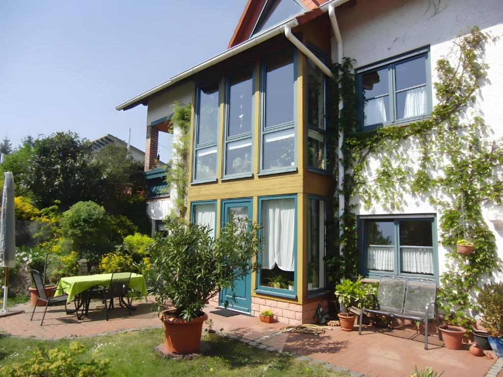 a house with a lot of windows and a patio at Ferienwohnung Rösner in Herzhausen