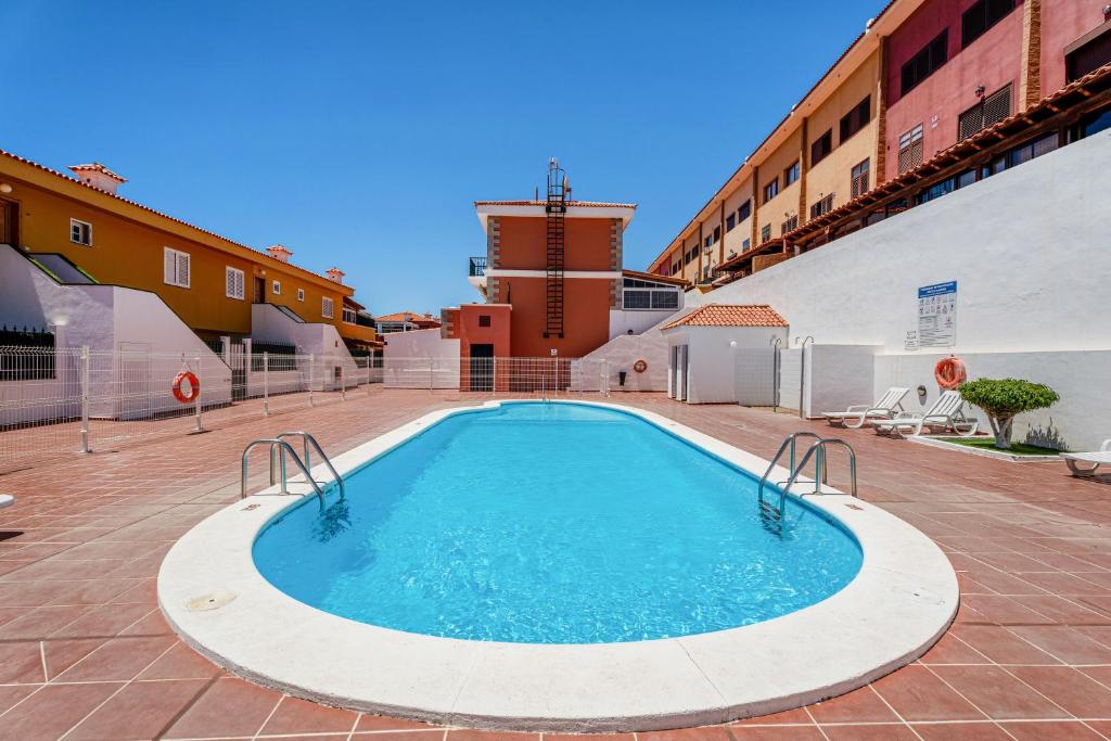 a pool in the middle of a building at Casa Brisas De Candelaria in Candelaria