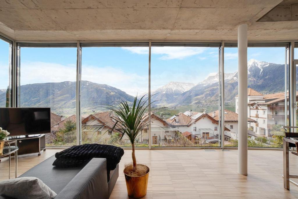a living room with a couch and a view of mountains at Villa Alvarium Eins in Schenna