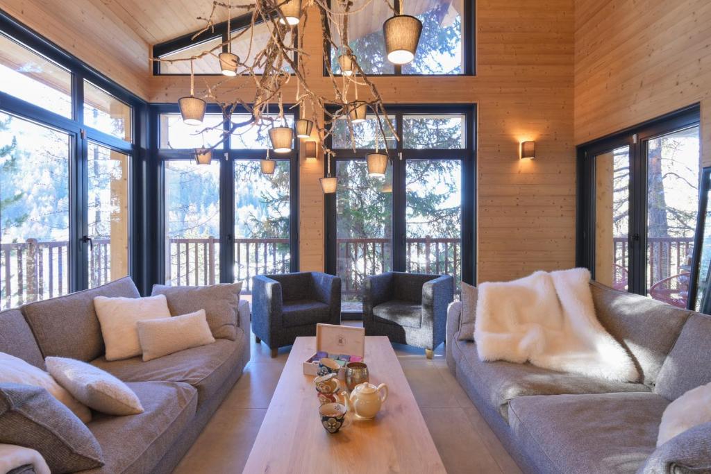 a living room with a couch and a table at Chalet avec Piscine La Plagne in La Plagne Tarentaise