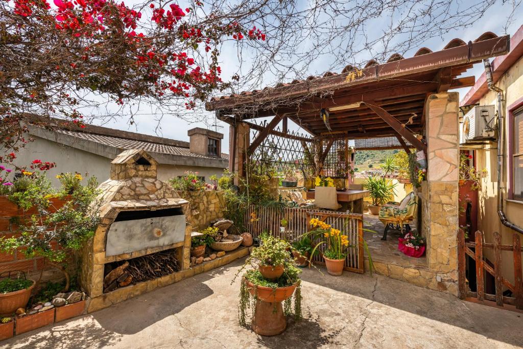 a garden with a stone fireplace in a yard at Monolocale Il Girasole in Villaputzu