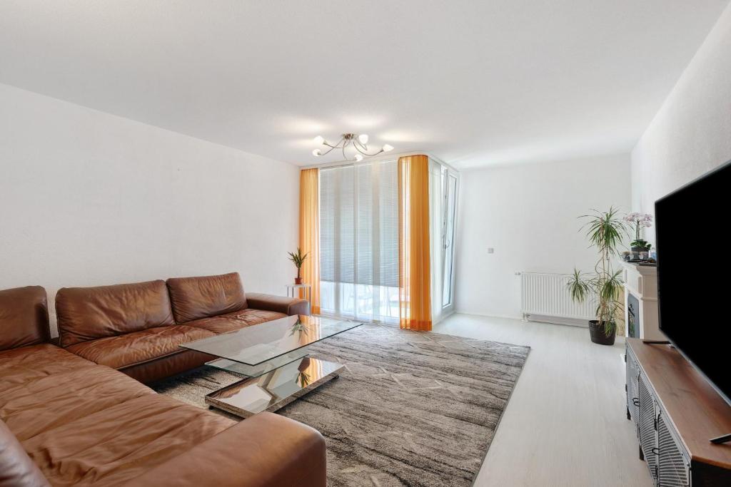 a living room with a couch and a table at eva Ferienwohnung in Engen
