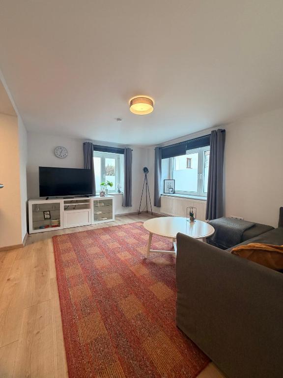 a living room with a couch and a table at Fewo im schönen Allensbach in Allensbach