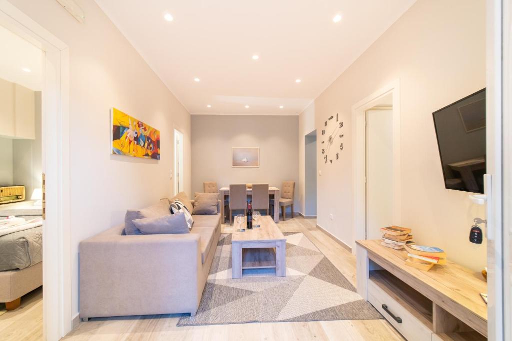 a living room with a couch and a tv at Seawind Gouvia in Corfu