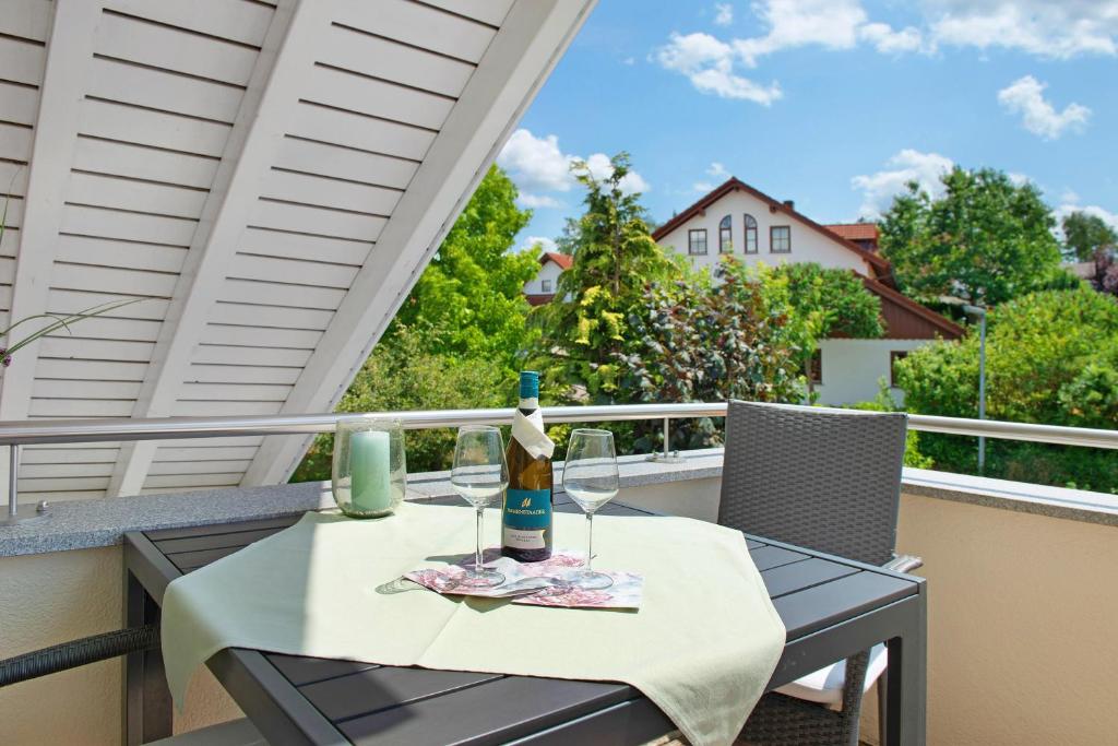 a table with a bottle of wine on a balcony at Wohlfühlplatz in Ostrach