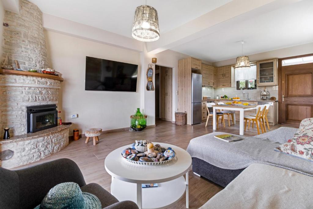 a living room with a couch and a table at Lefkada view villa Vasiliki 1 in Peratiá