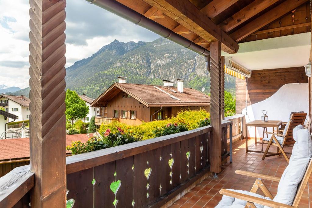 a balcony with a view of a house at Alpblick Apartment Alpspitze in Garmisch-Partenkirchen