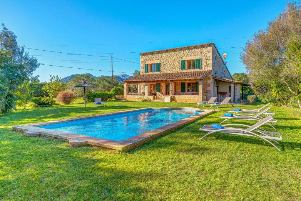 a house with a swimming pool in the yard at Can Vaja in Pollença