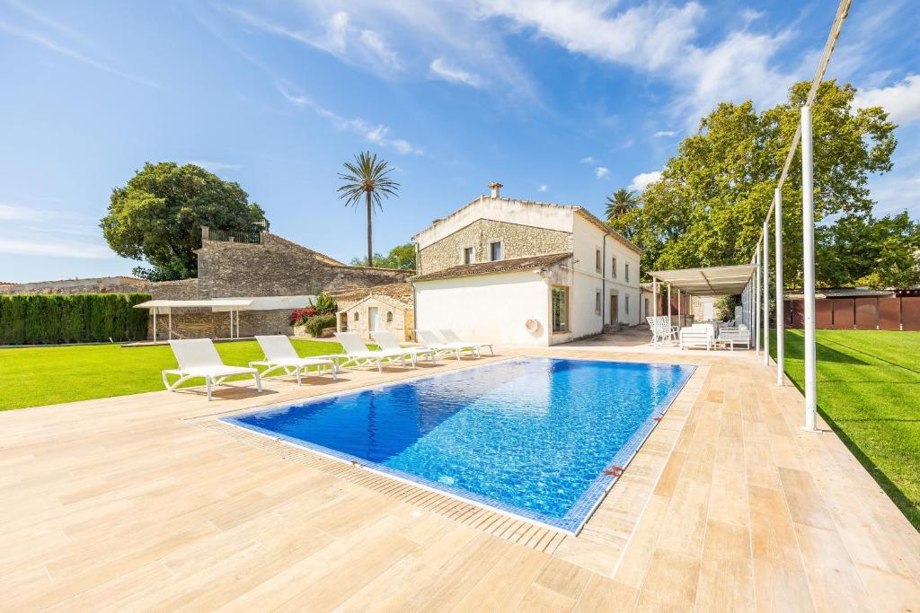 a swimming pool in the backyard of a house at Casa Con Piscina En Selva in El Port de la Selva
