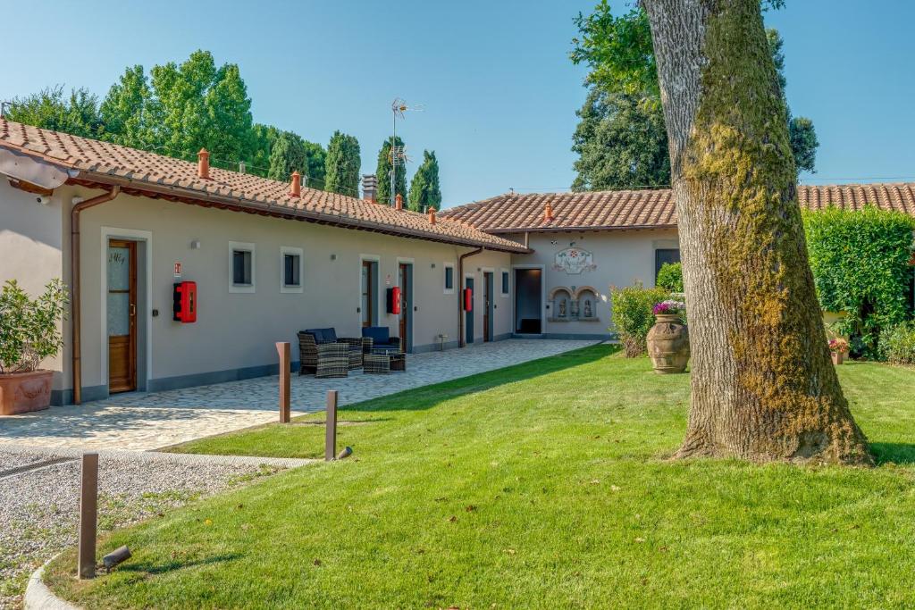 a house with a yard and a tree at Il Borghetto Bed and Breakfast in Borgo San Lorenzo