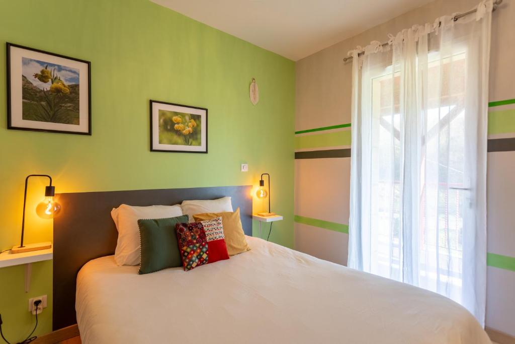 a bedroom with a white bed and a window at Chambre - Lis in Aroue