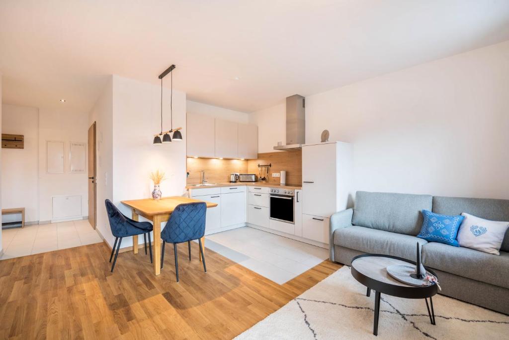a living room with a couch and a table at Ferienwohnung Max in Gilching