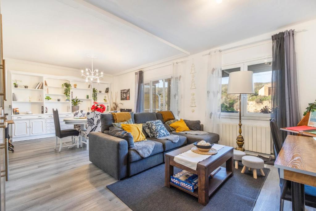 a living room with a couch and a table at Casa pablo y francisca in Alfarrás