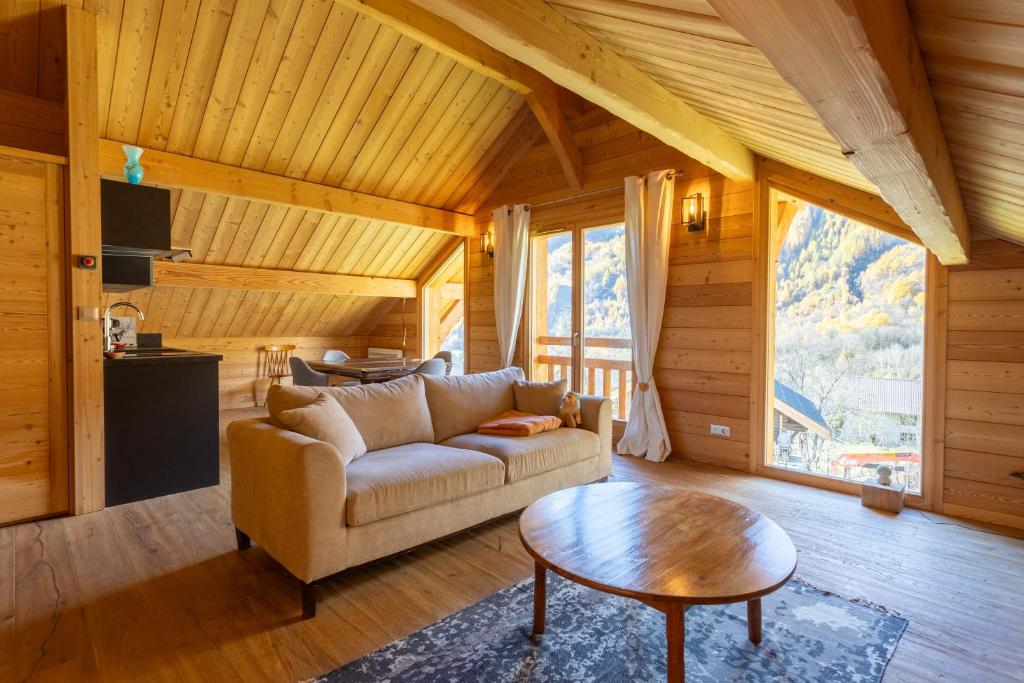 a living room with a couch and a table at Chalet Le Chastel in Pelvoux