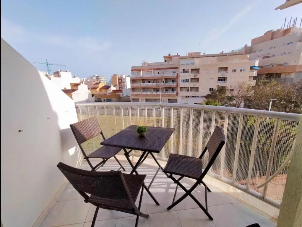 a table and chairs on a balcony with a view at R-06 Holiday Apartment La Mata in La Mata