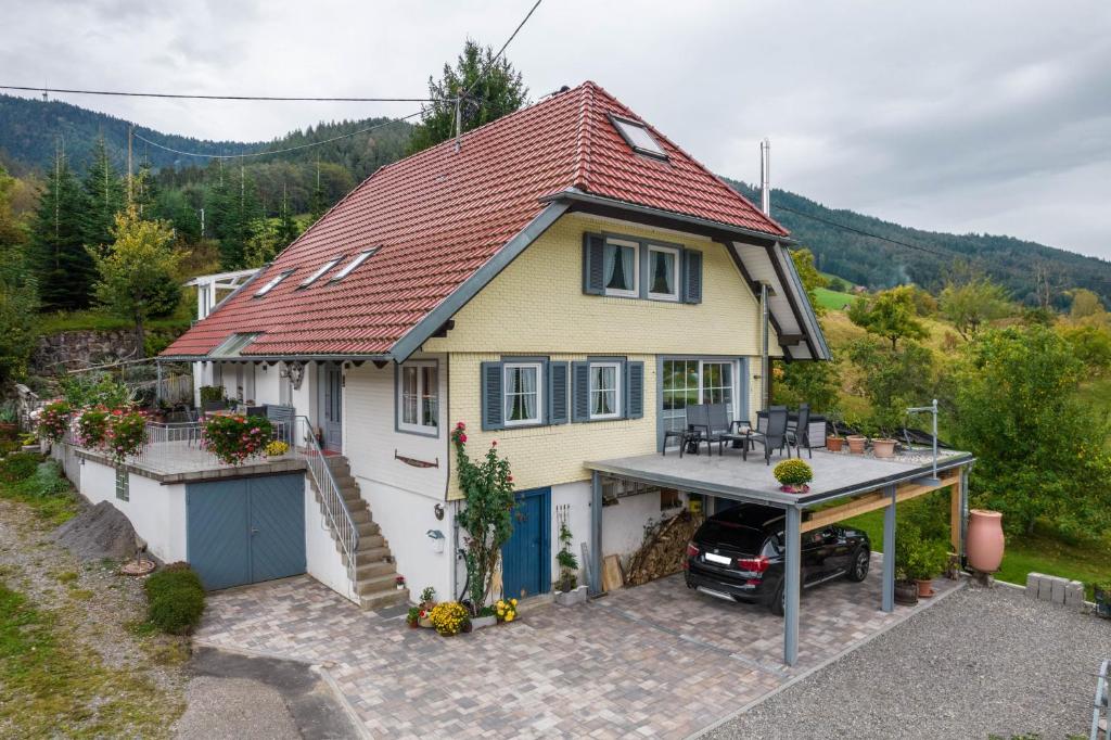 a house with a car parked in front of it at Lehmann mit Blick aufs Schloss in Gutach