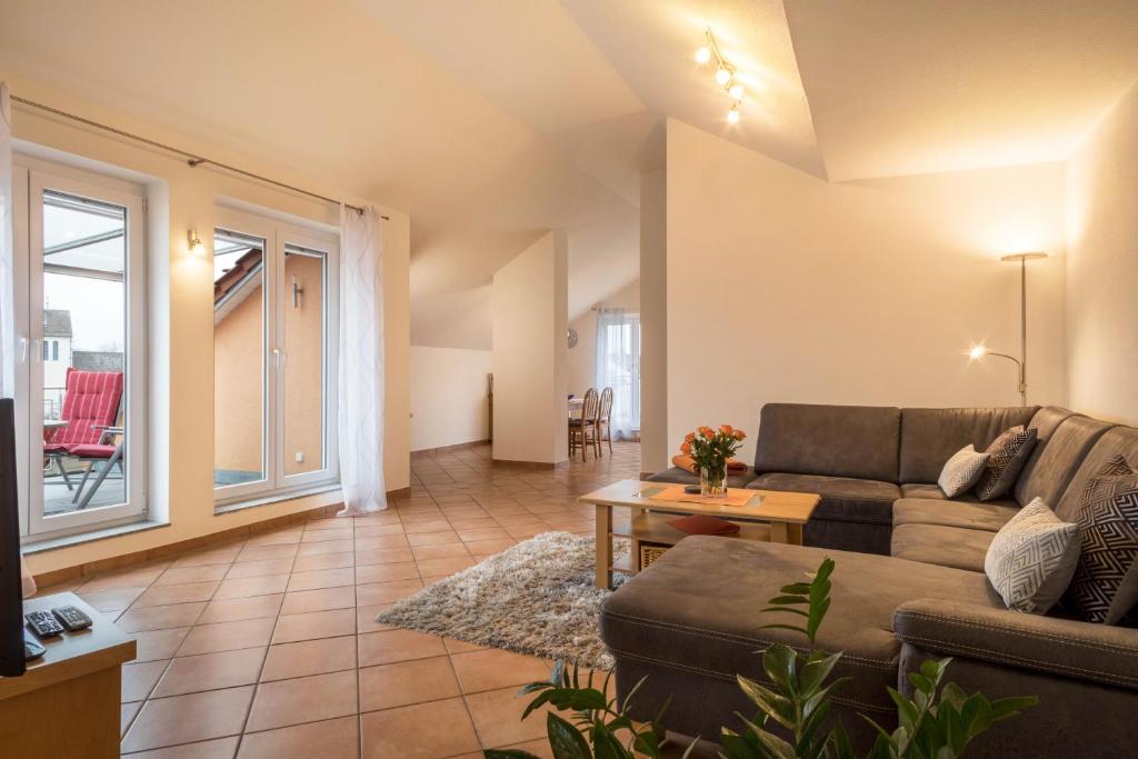 a living room with a couch and a table at Haus Sonnenseite Wohnung Pfänder in Wasserburg