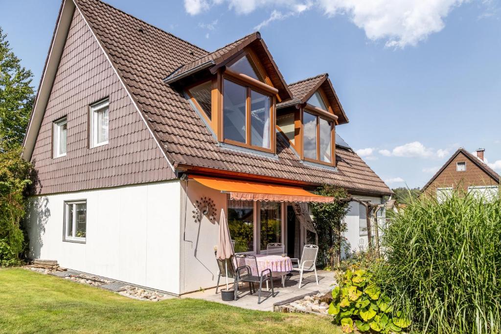 a house with a gambrel roof and a patio at Eule in Donaueschingen
