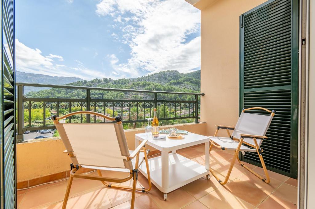 a balcony with a white table and two chairs at Soller beach apartment in Sóller