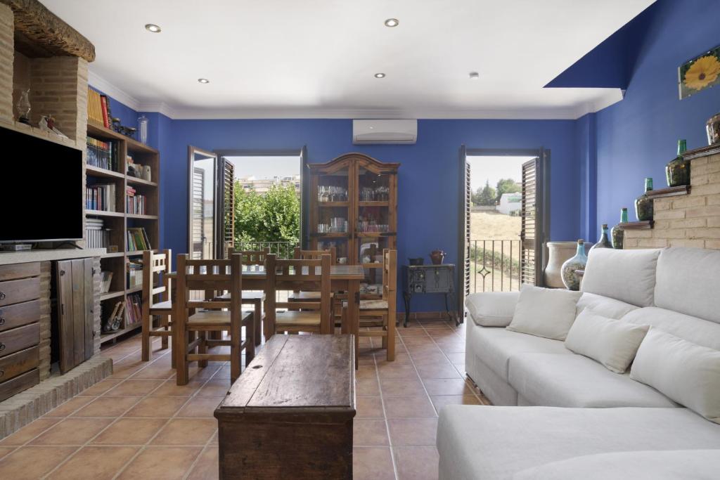 a living room with a couch and a table at Casa Las Niñas in Olvera
