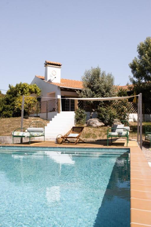 a swimming pool in front of a house at Casa do Vagar in Vimieiro