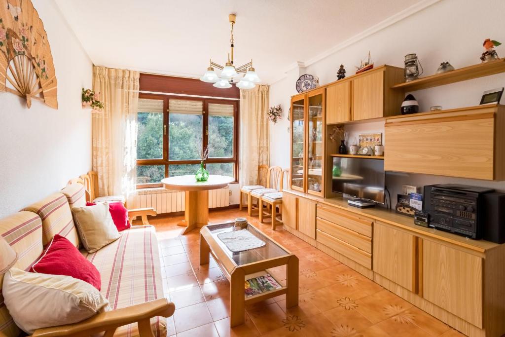a living room with a couch and a table at Mila Somo in Somo
