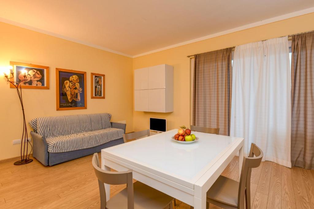 a living room with a white table and a couch at Colleincanto Appartamento Lina in Gavardo