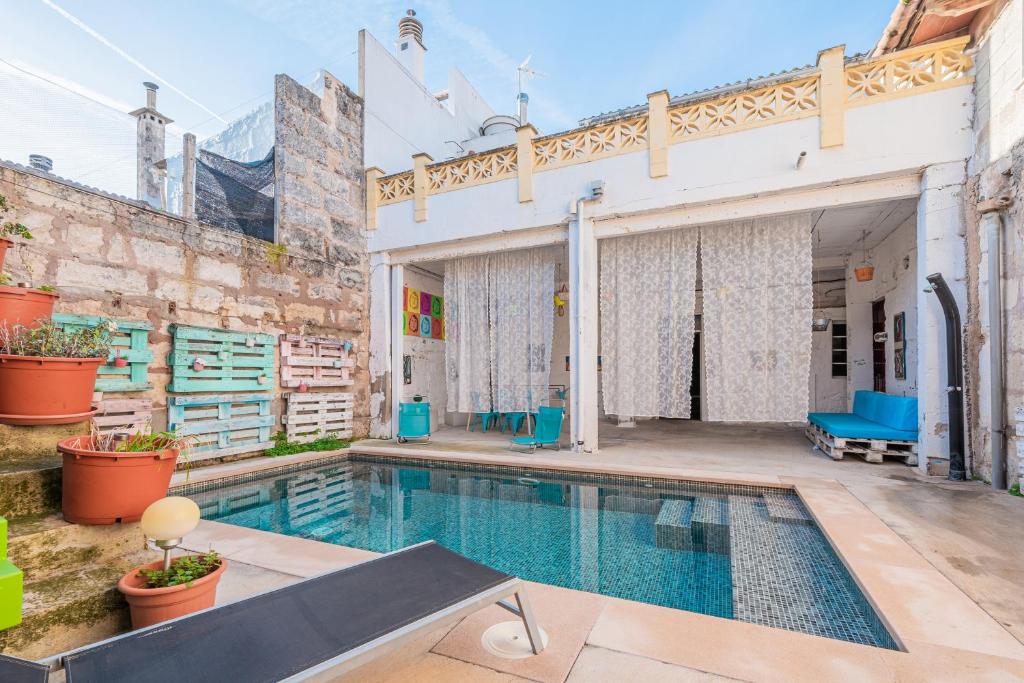 a swimming pool in the backyard of a building at Townhouse Can Miquel in Sa Pobla