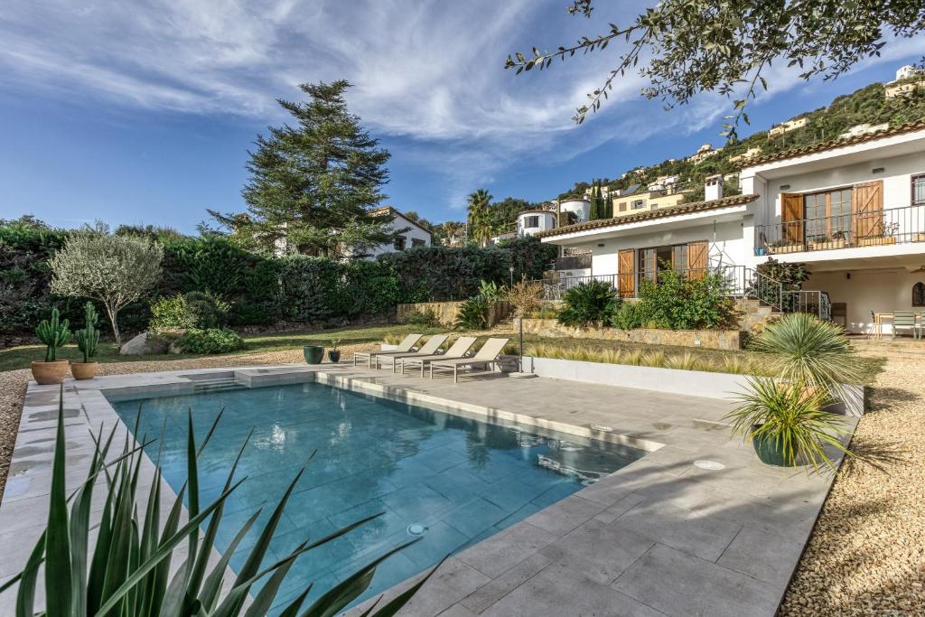 a swimming pool in the backyard of a house at Villa Les Aulines in Calonge