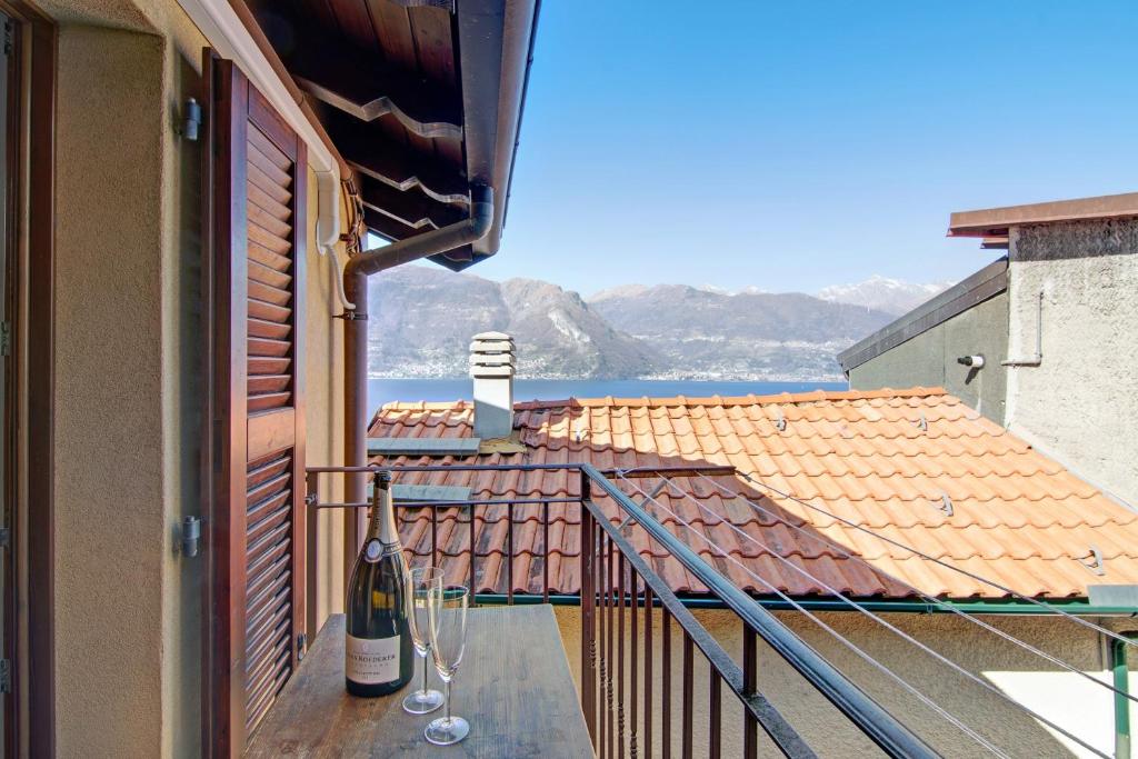 a balcony with a bottle of wine and wine glasses at Bernhouse in Dorio