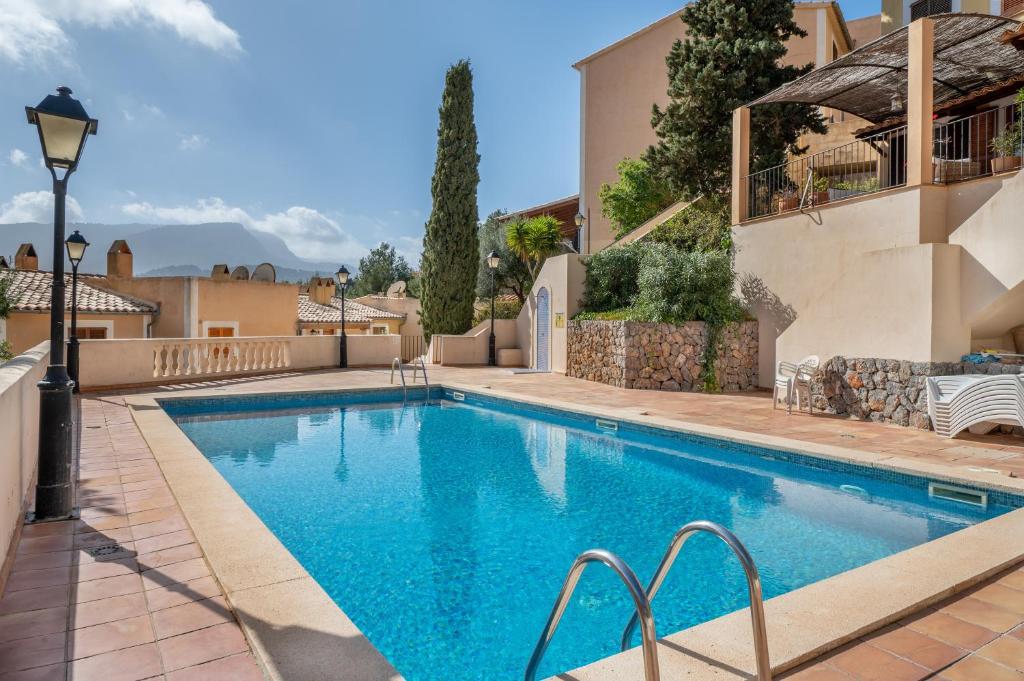 a swimming pool in front of a house at Vistasol Port de Soller in Sóller