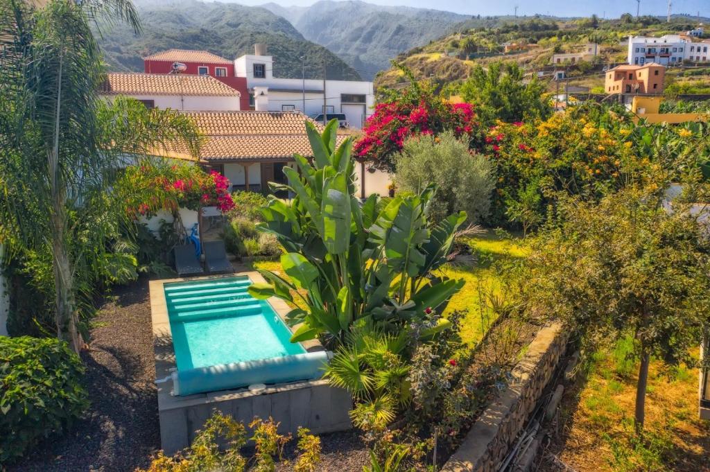 a villa with a swimming pool in a garden at El Bebedero de Los Sauces in San Andres y Sauces