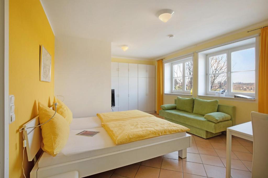 a living room with a couch and a chair at Birkethof Studio in Mickhausen