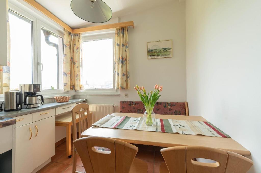 a kitchen and dining room with a table and chairs at Appartment Isabelle Home in Hermagor