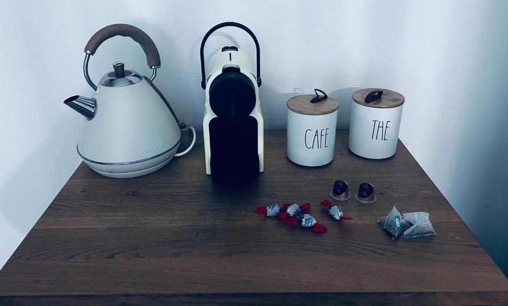 a table with a tea kettle and cups on it at Studio Pergaud in Besançon