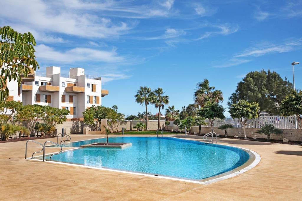 a swimming pool in front of a building at Edificio Los Martines in El Médano