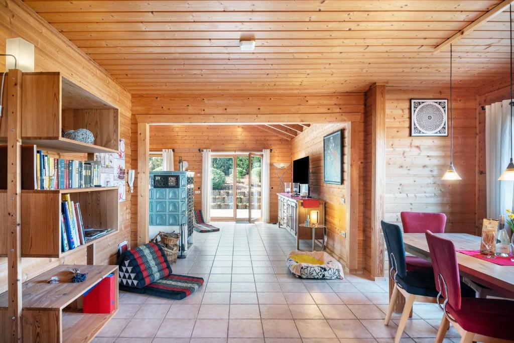 a living room with a table and a dining room at Landhaus-Eifelhöhe in Schüller