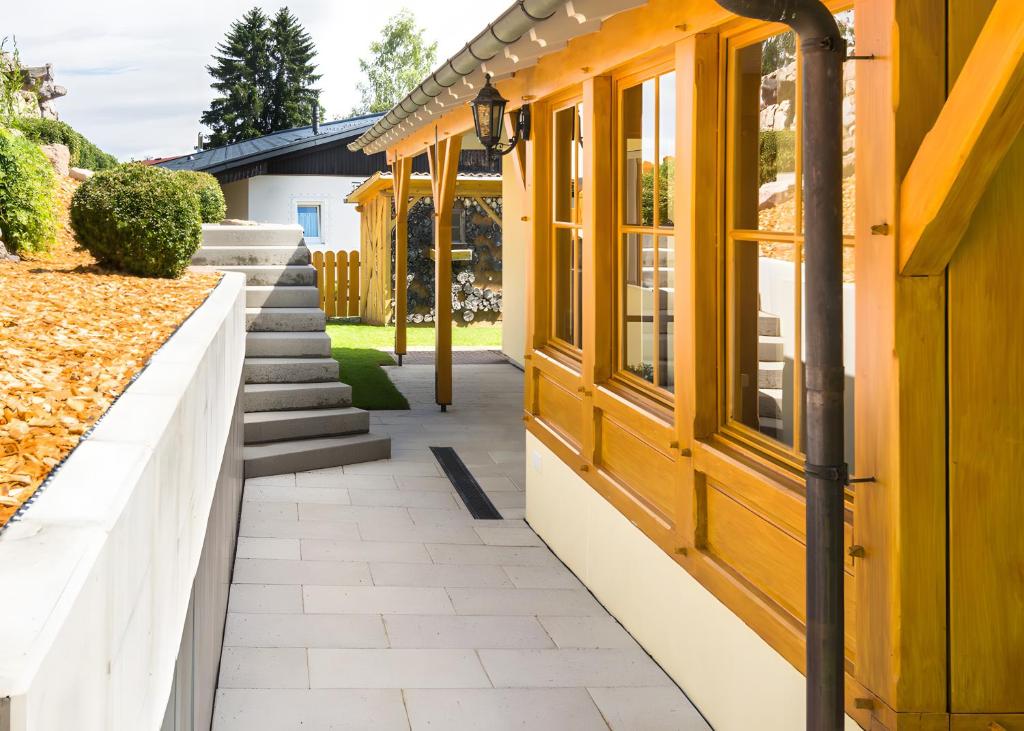 a house with yellow doors and a walkway at Ferienhaus Apfelbäumchen Lenzkirch in Lenzkirch