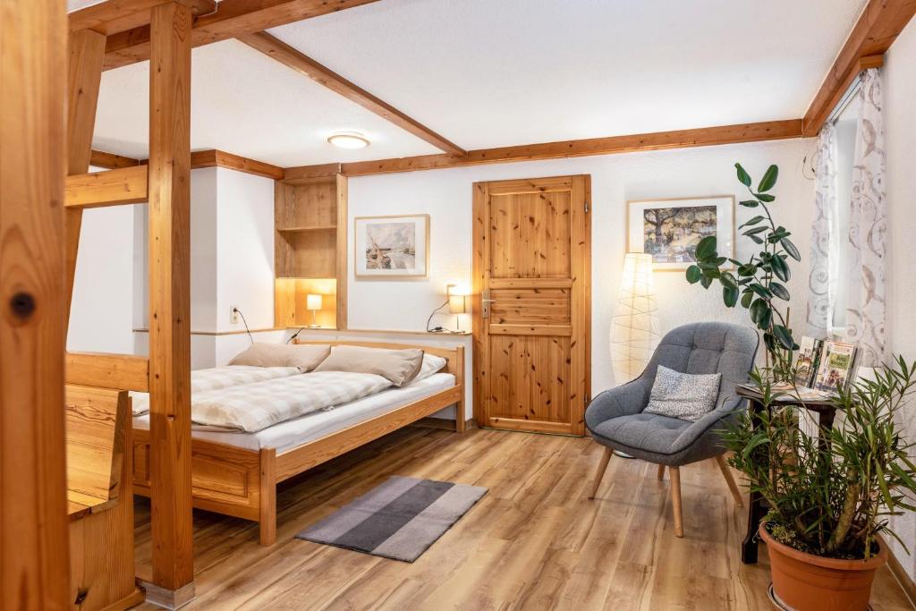 a bedroom with a bed and a chair in it at Ferienwohnung Am Schleifenbach 2 in Saalfeld
